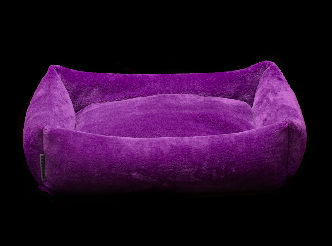 Izzydogg design dog bed with head rest in dark purple recycled fluffy faux fur with removable cover and high quality memory foam.