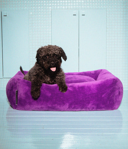 Izzydogg design dog bed with head rest in dark purple recycled fluffy faux fur with removable cover and high quality memory foam.